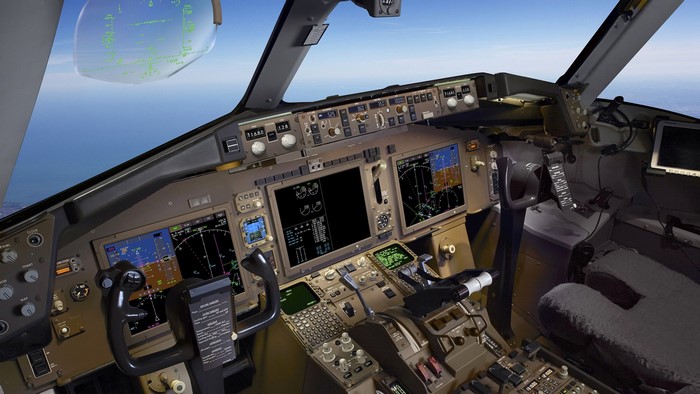 Airplane cockpit with multiple displays and controls