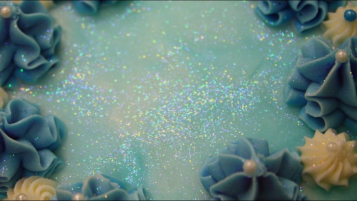 Blue and white frosted cake with glitter