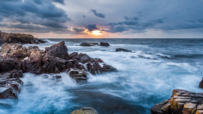Rocky Coastline with Waves and Dramatic Clouds