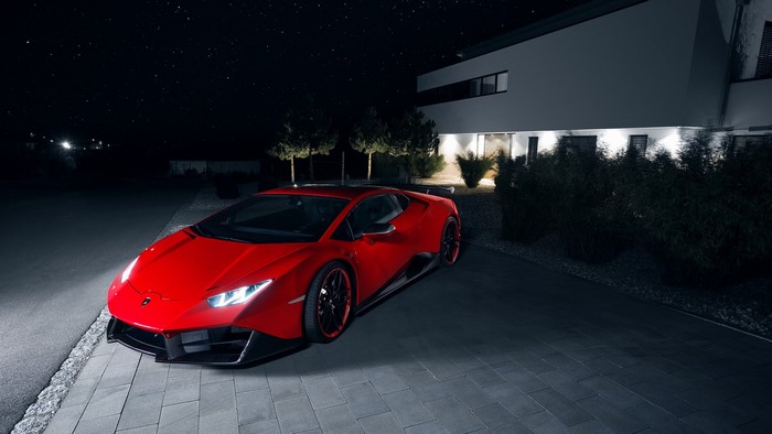 Red Lamborghini sports car parked at night