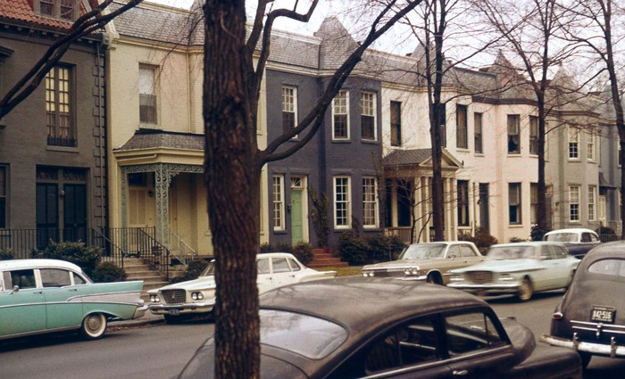 Row of houses with classic cars on street