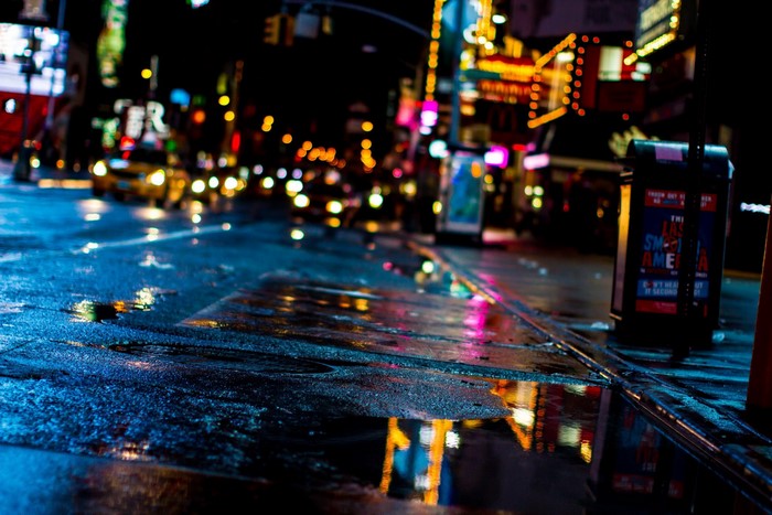 Wet city street at night with reflections