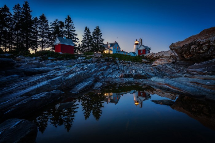 Lighthouse on rocky coast at dusk, Maine