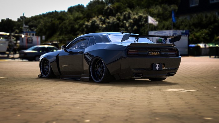 Black Dodge Challenger SRT with a large rear spoiler