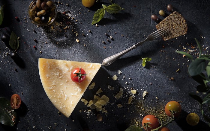 Parmesan cheese with tomatoes, olives, and herbs