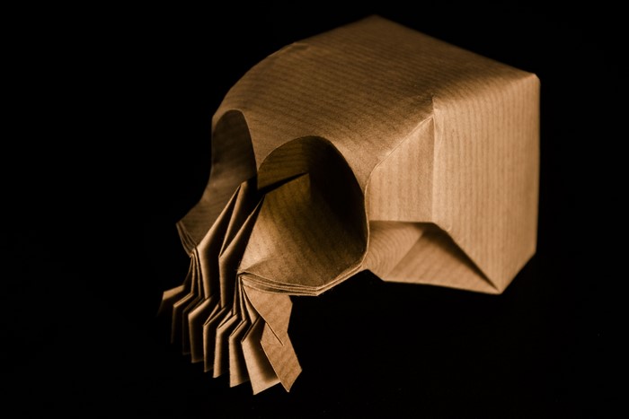 Origami skull artwork on black background
