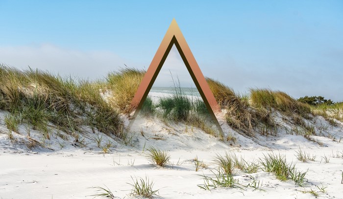 Triangle overlay on a sandy beach with dunes and sea