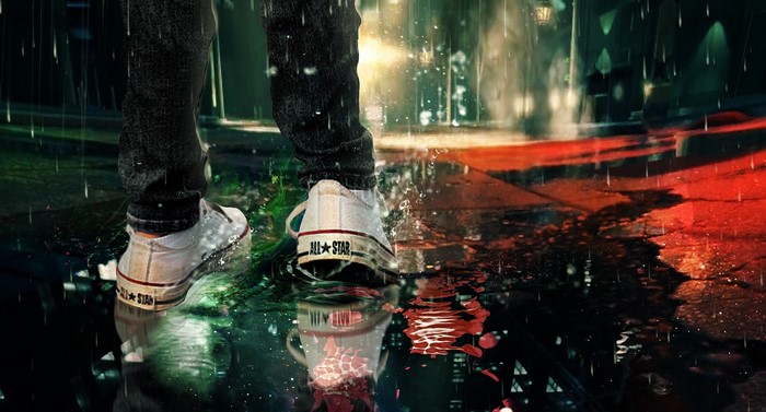 Person wearing Converse All Star sneakers in the rain