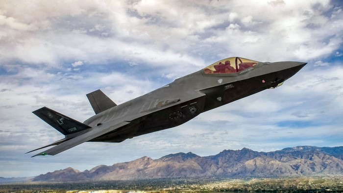 Lockheed Martin F-35 Lightning II flying over mountains
