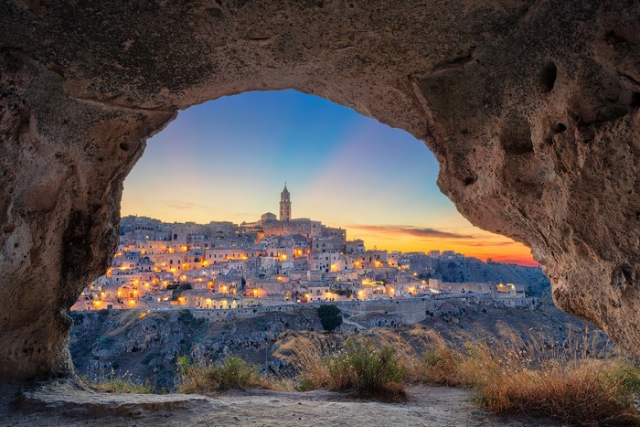 Matera, Italy cityscape viewed from a cave at sunset