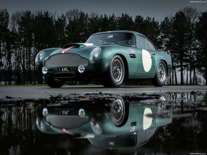 Green Aston Martin DB5 reflection in puddle