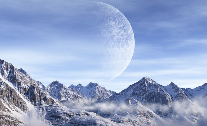 Snowy mountains under a large planet in the sky
