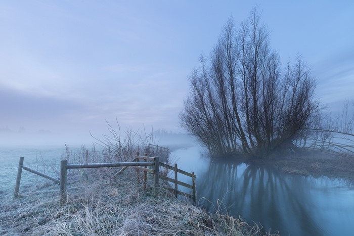 Winter landscape with fog and a river