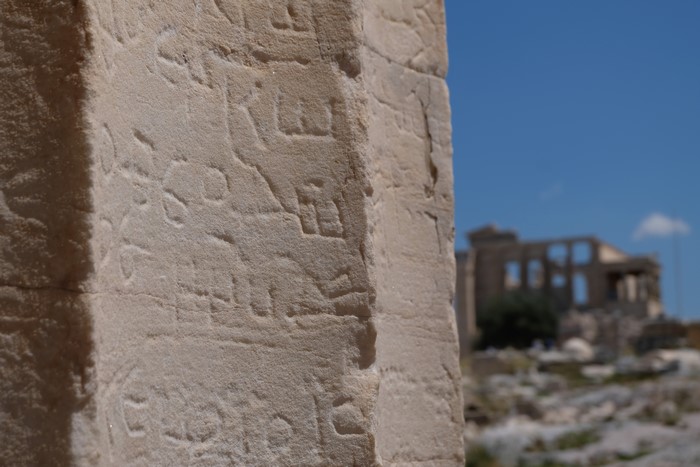 Ancient Greek inscriptions on stone pillar at Acropolis