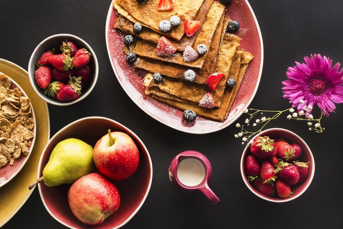 Still life of crepes with berries and fruit