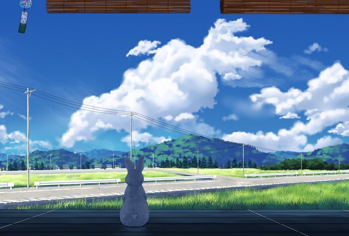 Rabbit statue looking at a rural landscape with clouds
