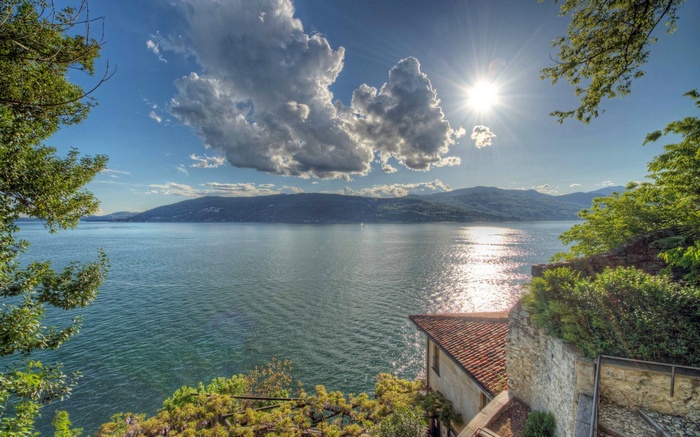 Lake with Mountains and Sunlit Clouds