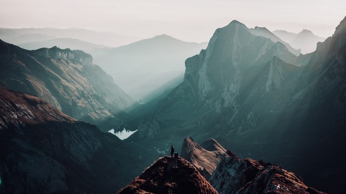 Person standing on a mountain peak in Switzerland