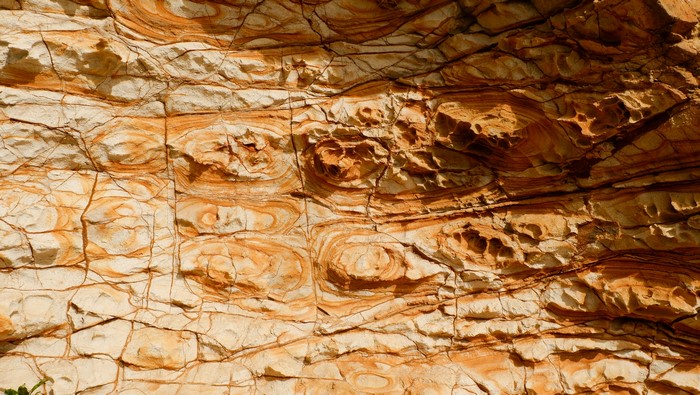 Rock formation with orange and white layers