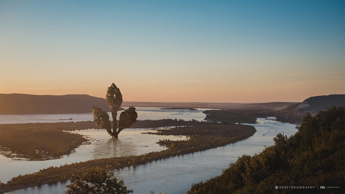 Surreal floating island in a river landscape at sunset