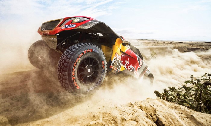 Peugeot Dakar Rally car kicking up dust