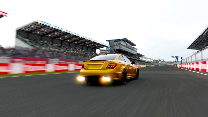 Yellow Mercedes-Benz C63 AMG Coupe on a race track