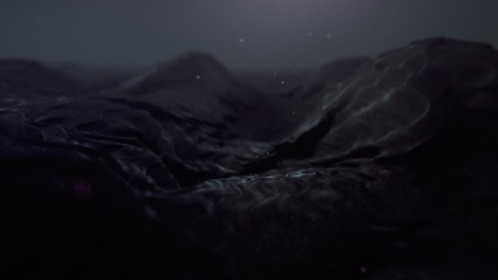 Dark abstract liquid surface with light reflections