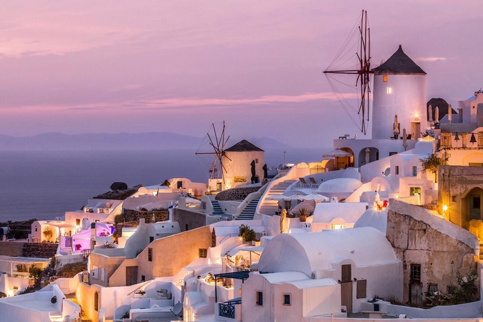 Santorini windmills at sunset with sea and pink sky
