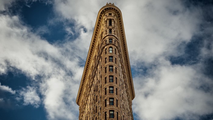 The Flatiron Building against a cloudy sky