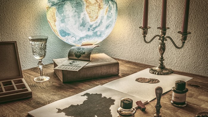 Desk with globe, candles, and maps