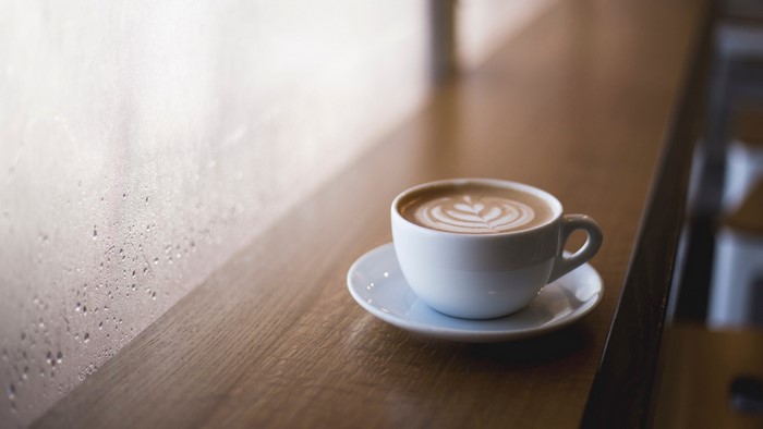 Cappuccino with latte art on a saucer