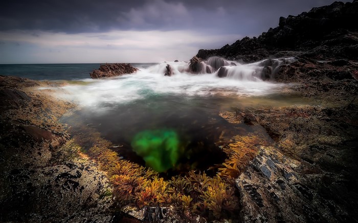 Long exposure of waves crashing on rocky coast