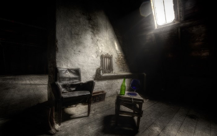 Old dark room with chair and bottle