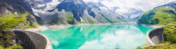Dam and turquoise lake in Austrian Alps