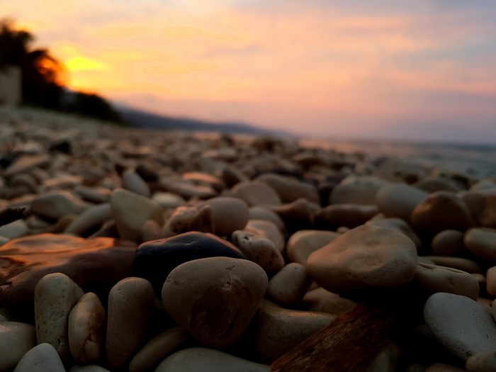 Pebbles on a beach at sunrise