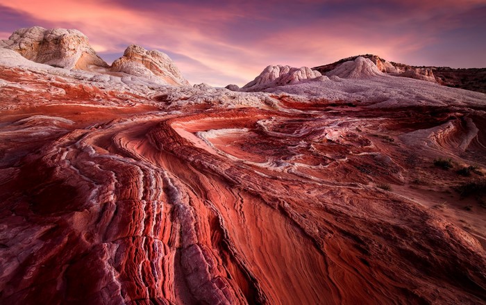 Red rock formations in Arizona under a colorful sunset sky