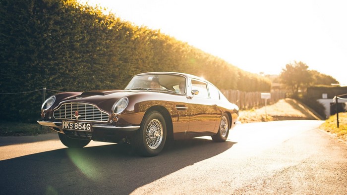 Aston Martin DB5 driving on a sunny road