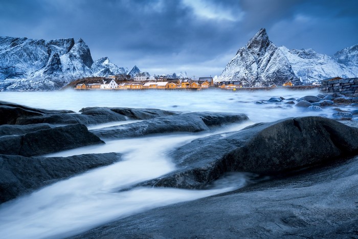 Snowy mountains and village by the sea in Norway