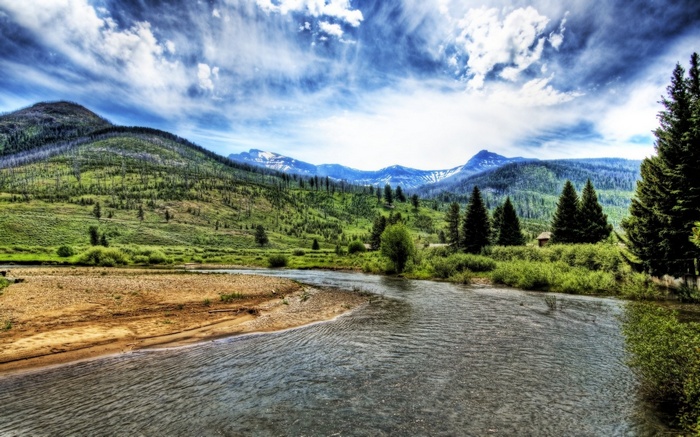 River flowing through a valley with mountains and trees
