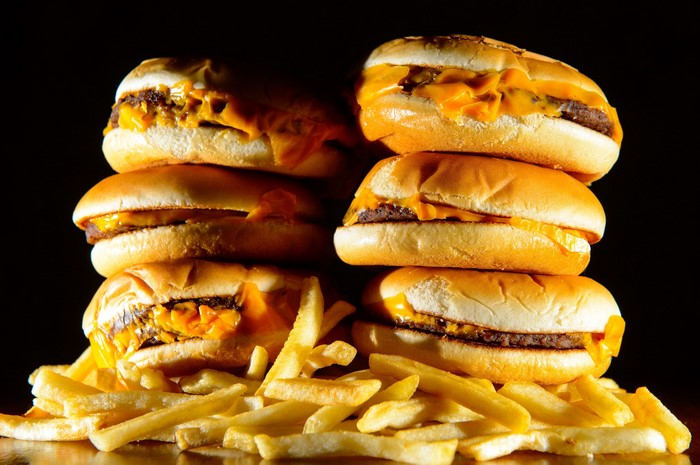 Stack of cheeseburgers and french fries