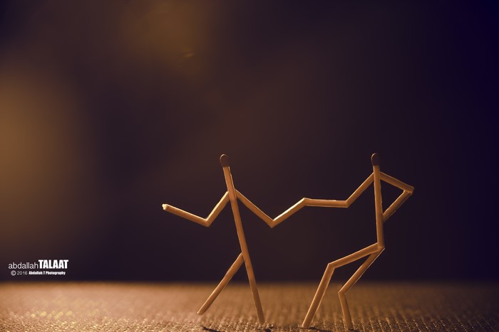 Two matchstick figures dancing