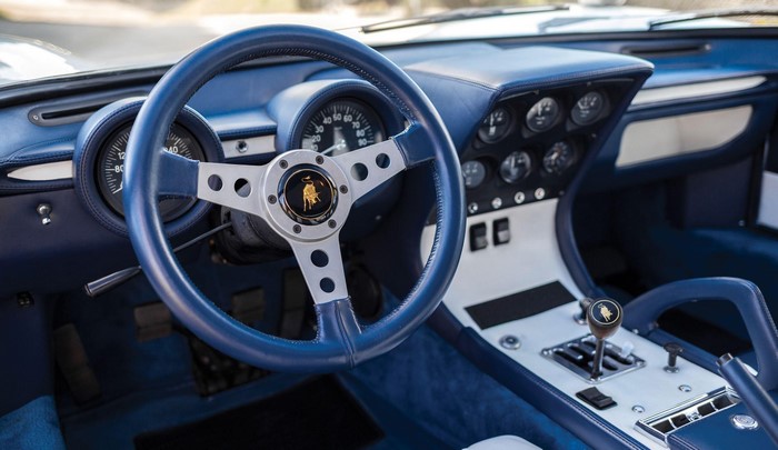 Lamborghini car interior with steering wheel and gear shift