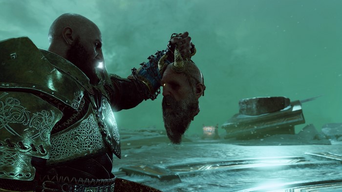 Kratos from God of War holding a severed head