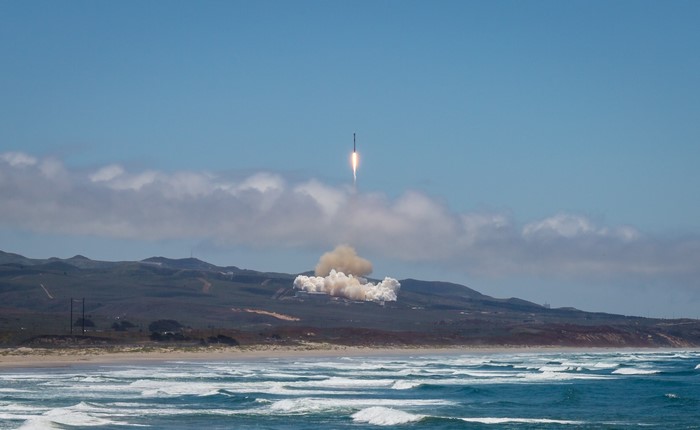 SpaceX rocket launch over a beach
