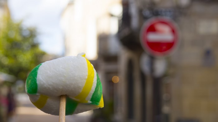 Candy on a stick with blurred city background