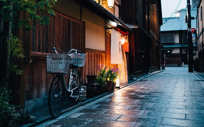 Bicycle parked on a wet street in Japan