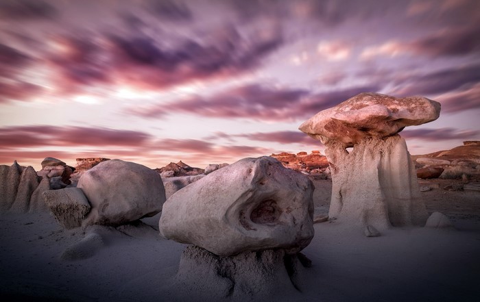 Rock formations under a colorful sky