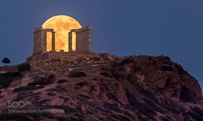 Super Blood Moon behind Temple of Poseidon ruins in Greece