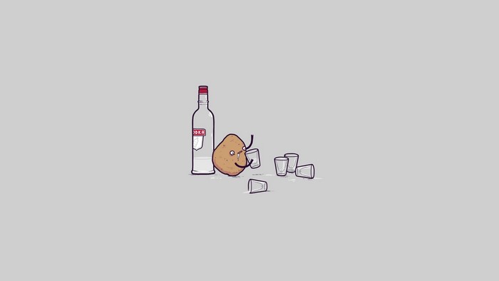 Potato drinking vodka with shot glasses
