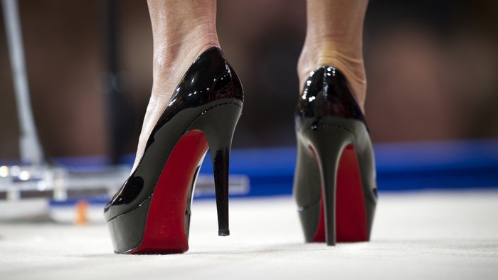 Close-up of black patent stiletto high heels with red soles
